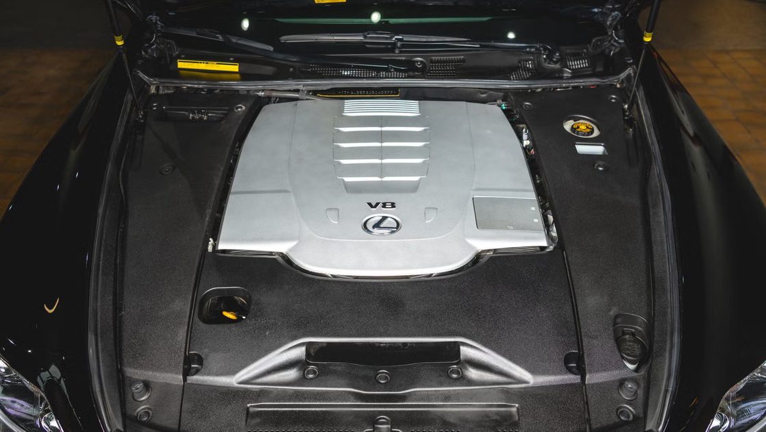 top view engine bay showing v8 engine cover surrounding components and strut towers.